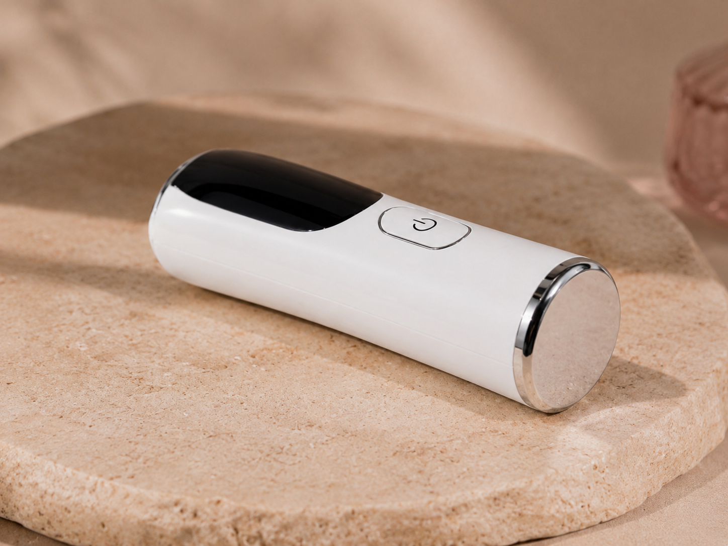 S.Rituelle Recovery Wand in Ivory White, lying on travertine stone